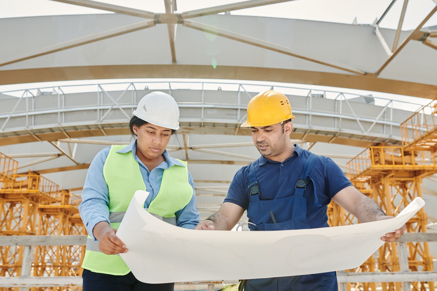 Construction professionals reviewing project plans on site